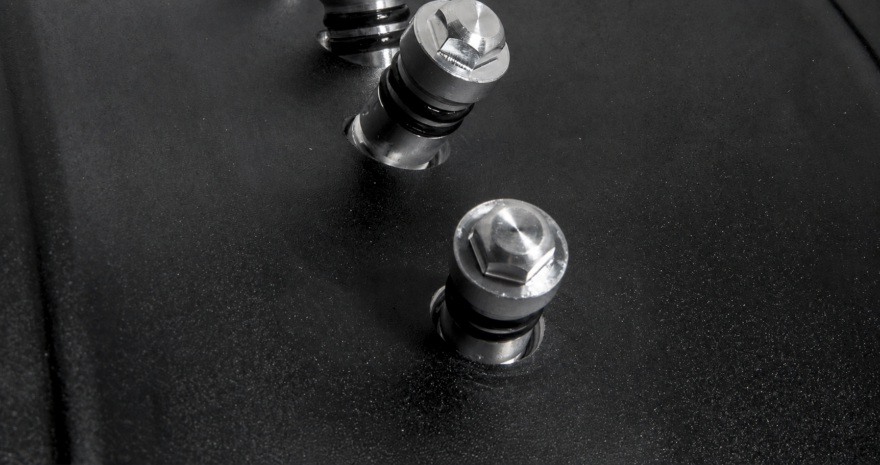 Close-up of reinforced motorcycle rim centre section and spoke nipple interfaces