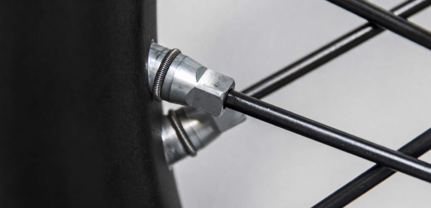 Close-up of motorcycle rim, spoke and nipple connection detail